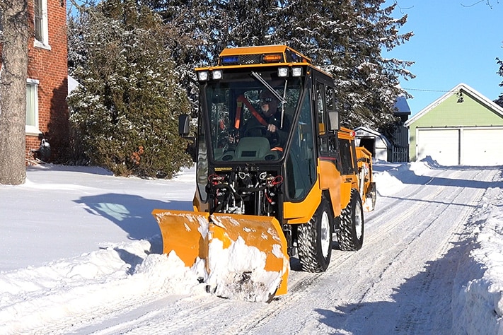 trackless vehicles 5-position folding v-plow attachment on sidewalk tractor in snow front view