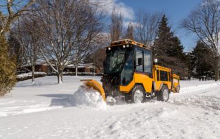 trackless vehicles mt7 tractor with plow removing snow from sidewalk