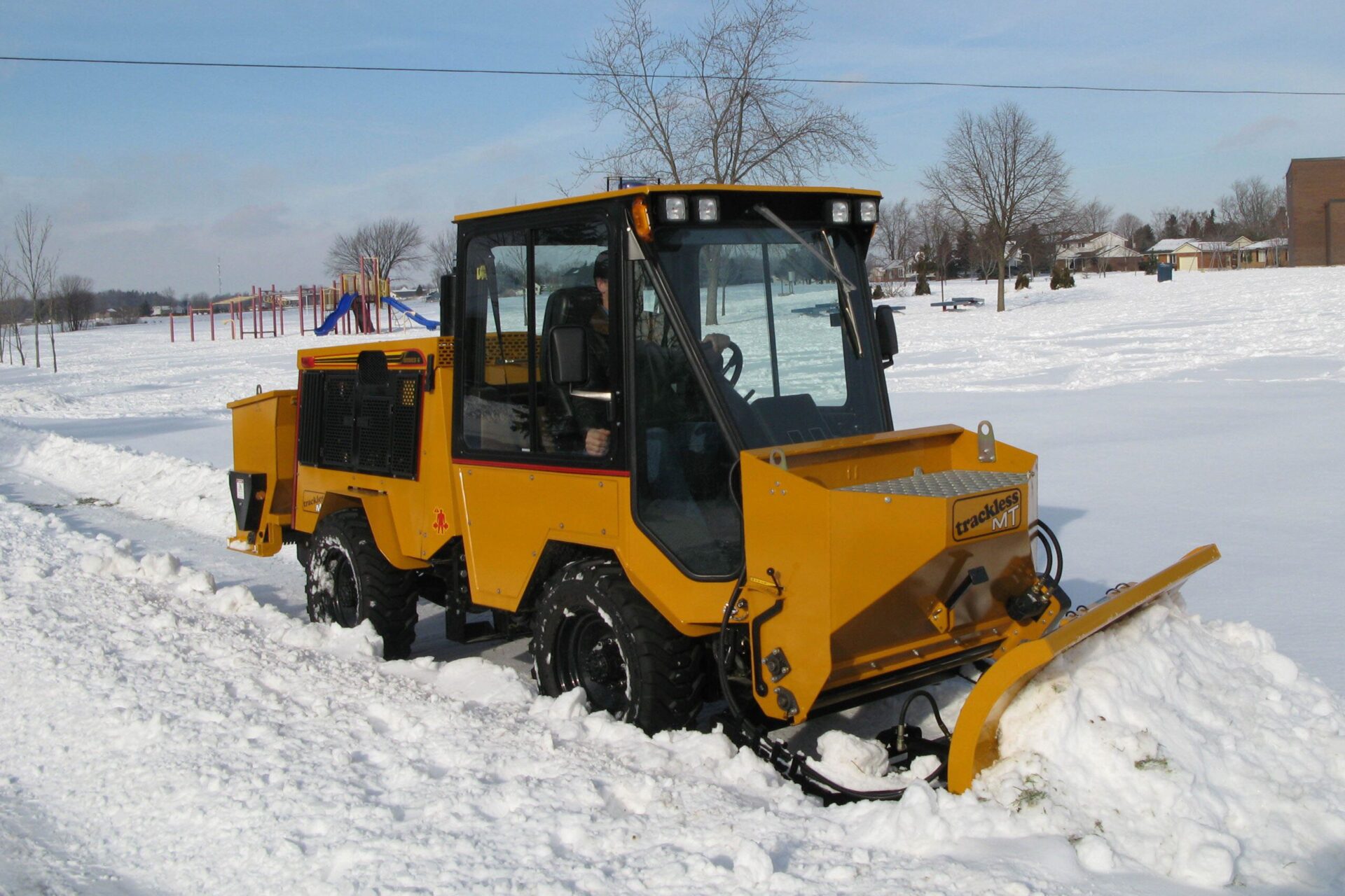 trackless vehicles mt6 tractor machine with front mount spreader and plow attachment