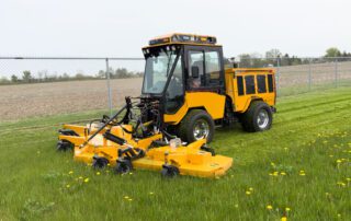 trackless vehicles mt7 tractor machine with rotary mower attachment mowing grass