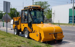 trackless vehicles mt7 machine and pickup sweeper attachment on sidewalk bike lane