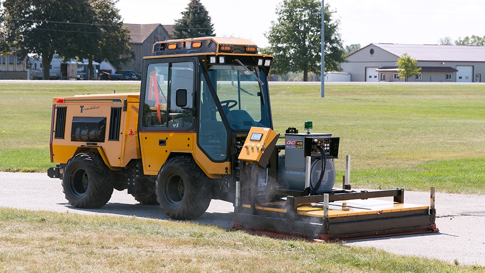 trackless vehicles infrared asphalt heater attachment on sidewalk tractor side view