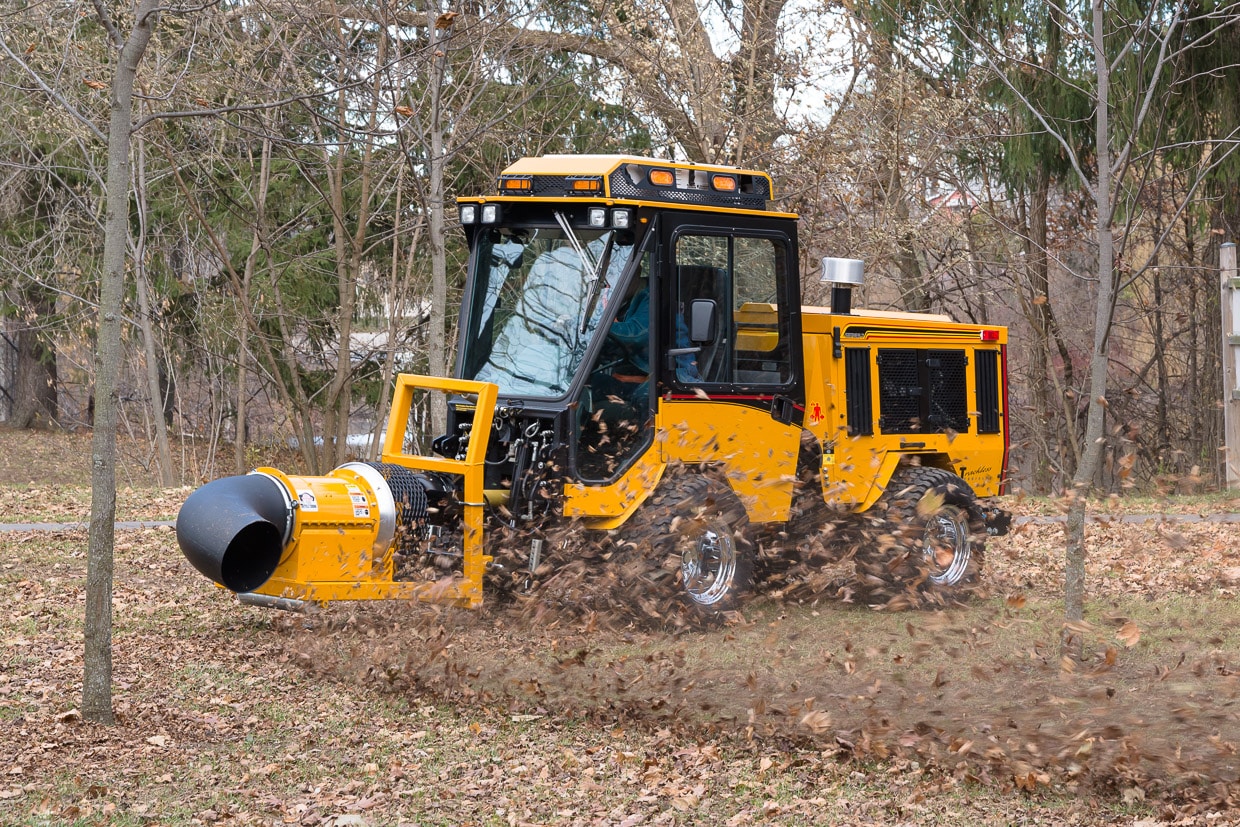 trackless vehicles buffalo turbine debris blower attachment on sidewalk municipal tractor blowing leaves side view