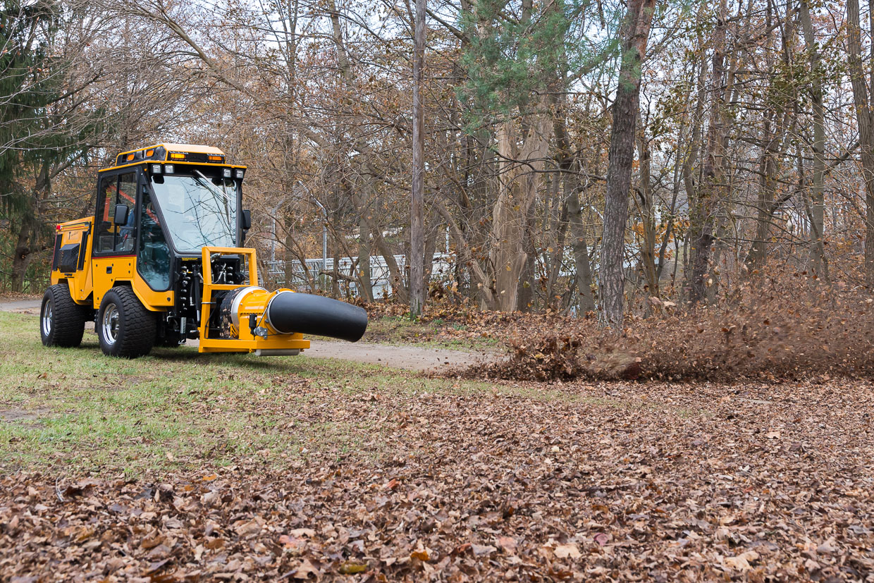 trackless vehicles buffalo turbine debris blower attachment on sidewalk municipal tractor blowing leaves side view