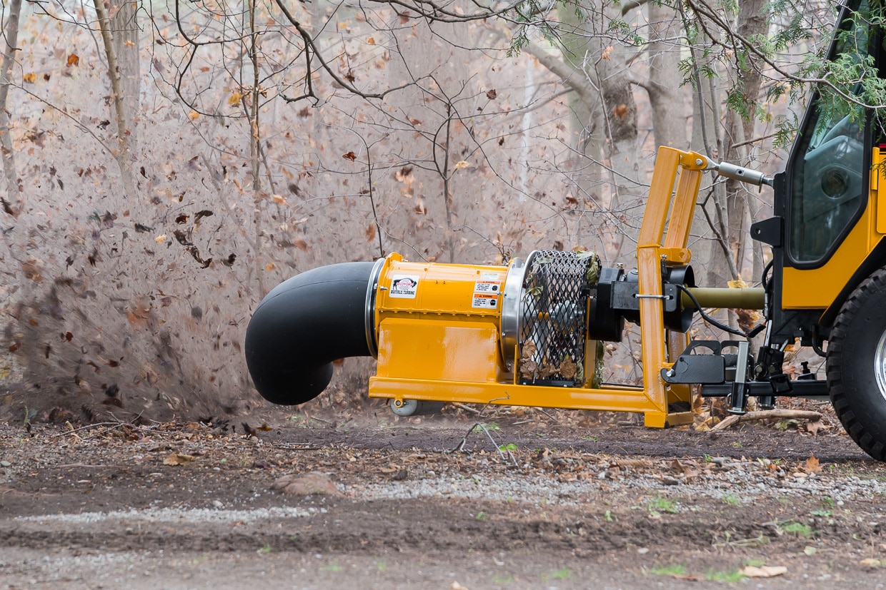 trackless vehicles buffalo turbine debris blower attachment on sidewalk municipal tractor blowing leaves side view close-up