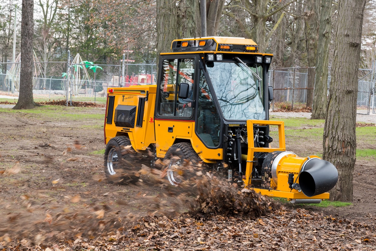 trackless vehicles buffalo turbine debris blower attachment on sidewalk municipal tractor blowing leaves side view