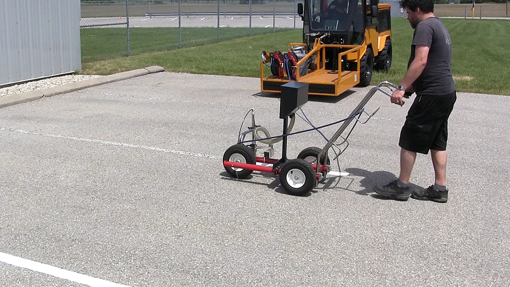 snow on ground before trackless vehicles 5-position folding v-plow attachment on sidewalk tractor