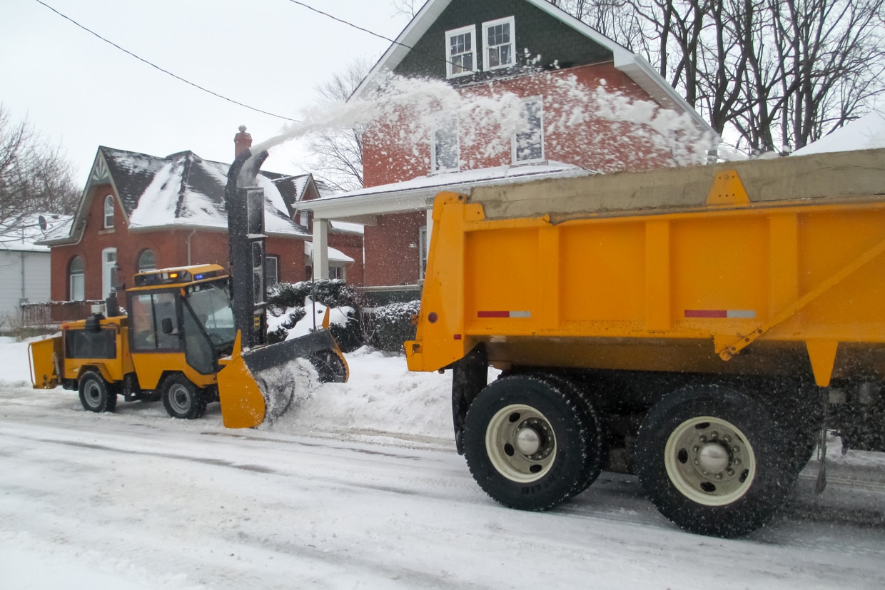 trackless vehicles ribbon snowblower in snow on sidewalk