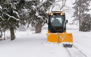 trackless vehicles 5-position folding v-plow attachment on sidewalk tractor in snow front view