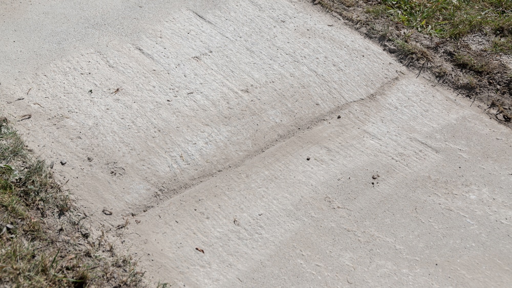 snow on ground after trackless vehicles 5-position folding v-plow attachment on sidewalk tractor